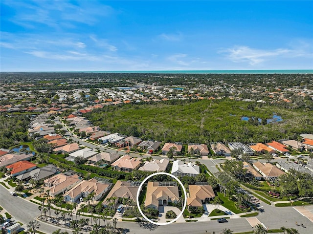 drone / aerial view featuring a residential view and a water view