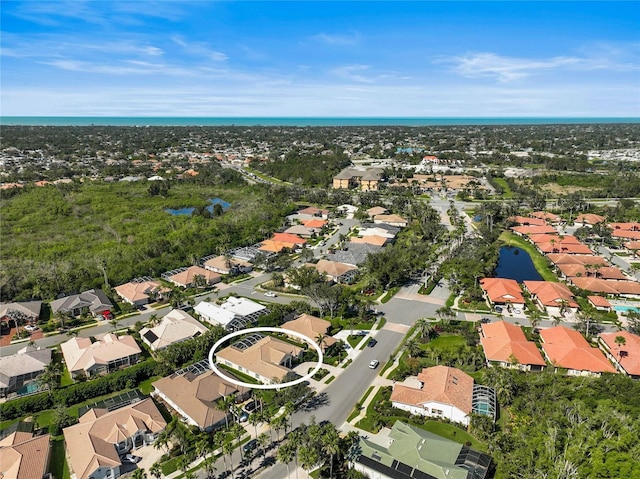 bird's eye view with a residential view and a water view