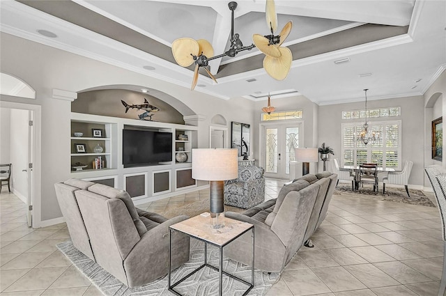 living room with built in features, french doors, crown molding, and light tile patterned floors