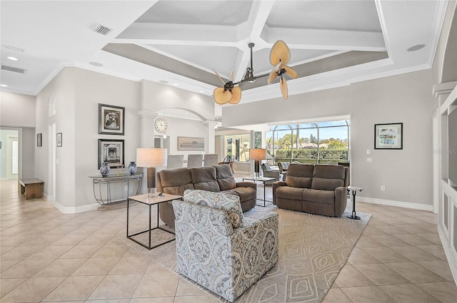 living room featuring light tile patterned floors, visible vents, a towering ceiling, and ornate columns