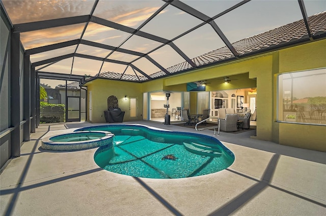 view of pool featuring a pool with connected hot tub, glass enclosure, outdoor dining area, a patio area, and a ceiling fan