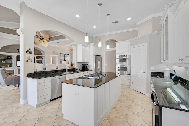 kitchen with light tile patterned flooring, visible vents, a kitchen island, and stainless steel appliances