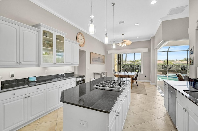 kitchen featuring visible vents, ceiling fan, stainless steel appliances, crown molding, and a center island