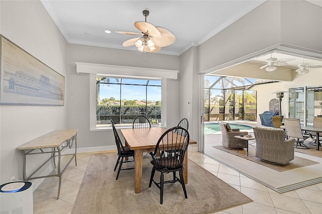 dining room featuring crown molding, light tile patterned flooring, a ceiling fan, and a sunroom