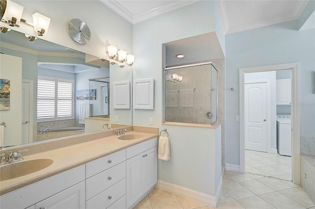 full bathroom with a sink, washer / clothes dryer, ornamental molding, and a shower stall