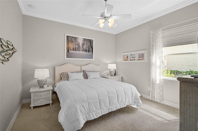 carpeted bedroom with ceiling fan, baseboards, and ornamental molding