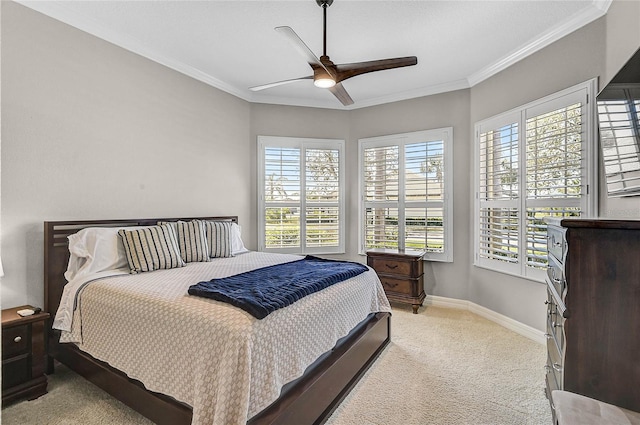 carpeted bedroom with ceiling fan, baseboards, and ornamental molding