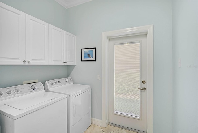 laundry area featuring light tile patterned floors, baseboards, cabinet space, and independent washer and dryer