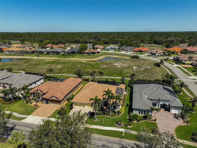 drone / aerial view with a residential view and a water view