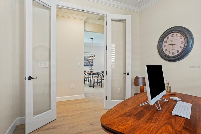 office space featuring light wood-style flooring, baseboards, ornamental molding, and french doors