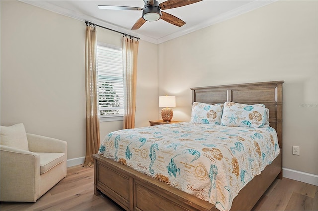 bedroom featuring light wood-type flooring, baseboards, and crown molding