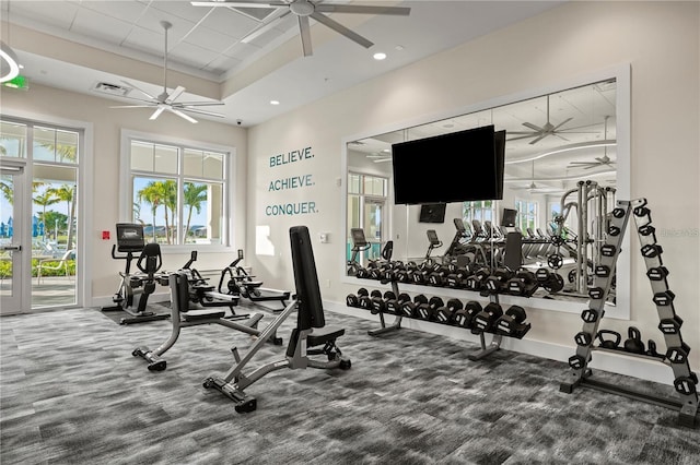 exercise room with visible vents, baseboards, recessed lighting, a ceiling fan, and a raised ceiling