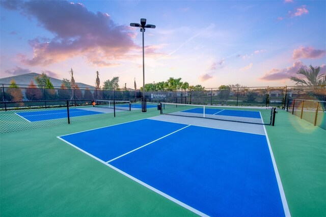view of tennis court featuring fence