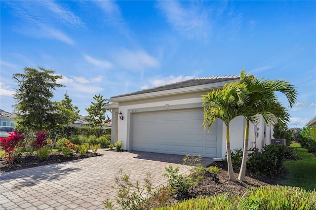 garage with decorative driveway