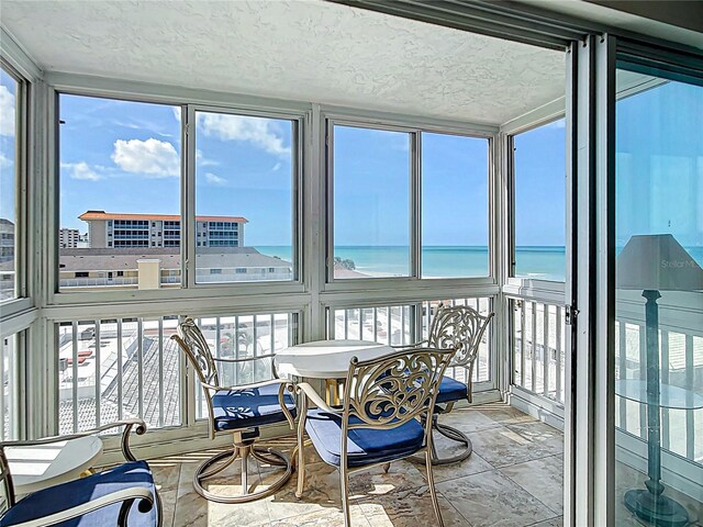 1255 Tarpon Center Dr Unit 503, Venice, FL 34285 - sunroom / solarium with stone finish flooring, a water view, and a textured ceiling