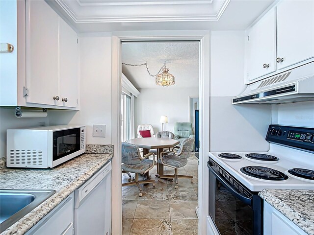 1255 Tarpon Center Dr Unit 503, Venice, FL 34285 - kitchen featuring white appliances, under cabinet range hood, a chandelier, light stone finish flooring, and white cabinets