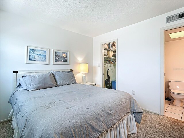 1255 Tarpon Center Dr Unit 503, Venice, FL 34285 - bedroom featuring light carpet, baseboards, a textured ceiling, and light tile patterned flooring