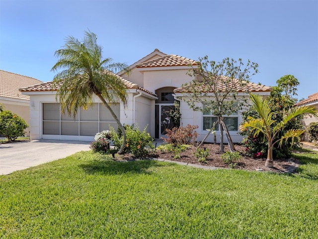 mediterranean / spanish house featuring stucco siding, a front lawn, driveway, a tile roof, and a garage