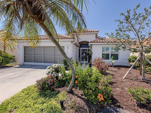 view of front of home featuring a tile roof, stucco siding, concrete driveway, and a garage