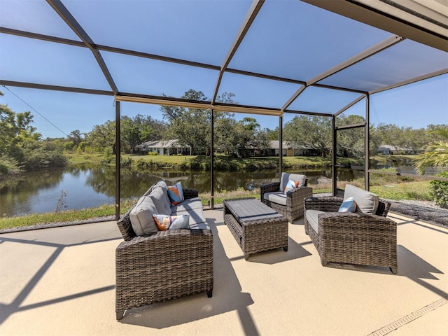 view of patio featuring a lanai, outdoor lounge area, and a water view