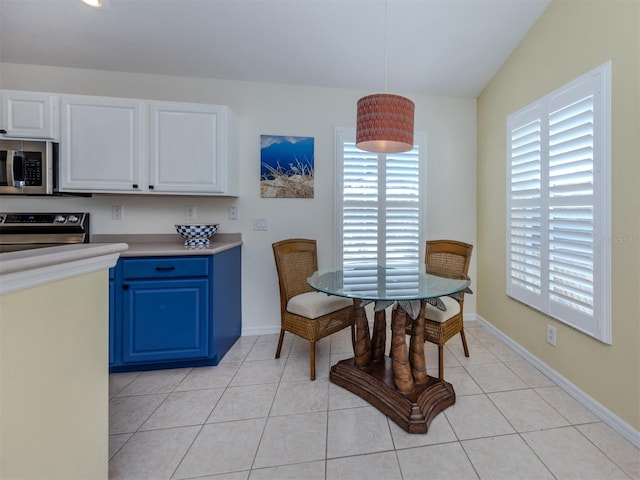 dining room with light tile patterned floors and baseboards