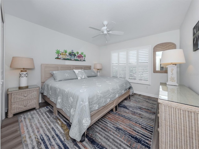 bedroom with baseboards, wood finished floors, and a ceiling fan