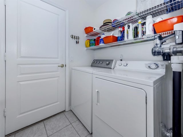 clothes washing area with light tile patterned floors, laundry area, and separate washer and dryer