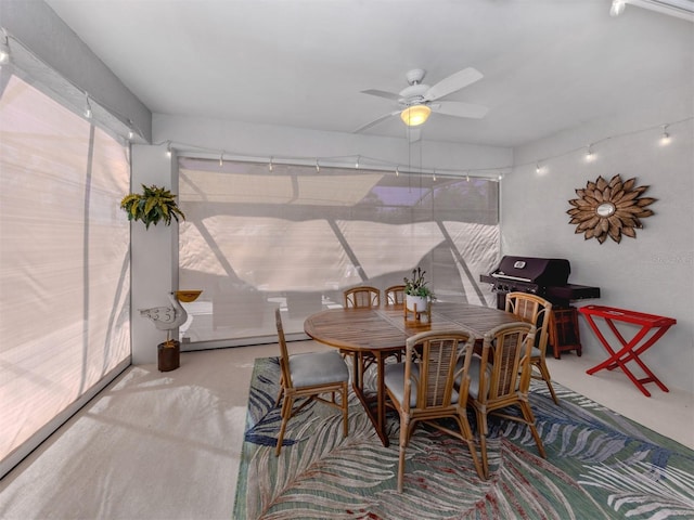 dining area featuring concrete flooring and a ceiling fan