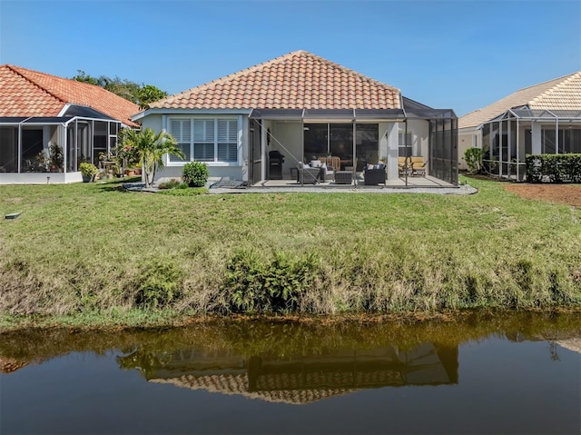 rear view of property featuring a patio, a water view, a lanai, a tiled roof, and an outdoor hangout area