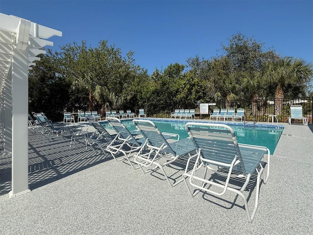 community pool featuring a patio and fence