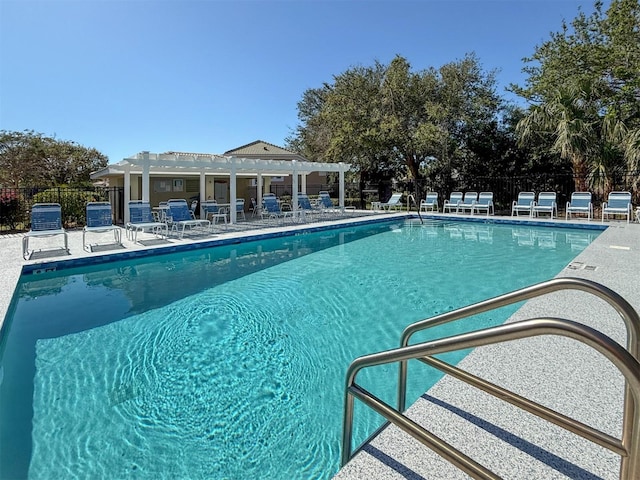 pool featuring a patio, fence, and a pergola