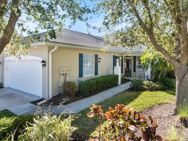 single story home featuring stucco siding, driveway, an attached garage, and a tiled roof