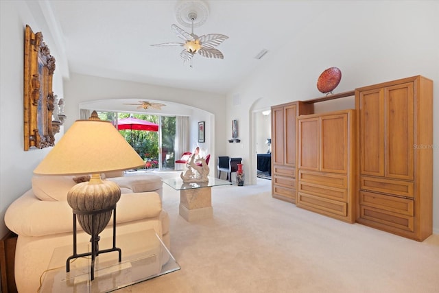 living area with visible vents, high vaulted ceiling, a ceiling fan, arched walkways, and light colored carpet