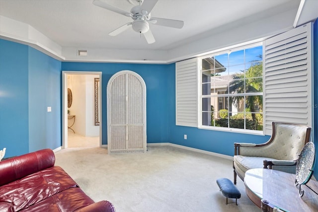 sitting room with visible vents, baseboards, a ceiling fan, and carpet flooring