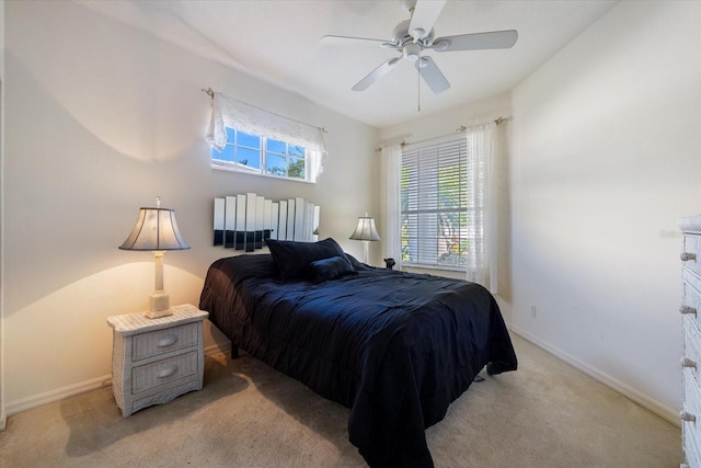 bedroom featuring baseboards, light carpet, and a ceiling fan