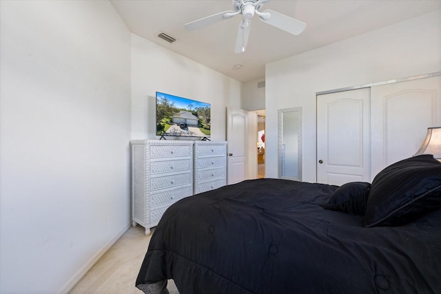 bedroom with a ceiling fan, visible vents, baseboards, a closet, and light colored carpet