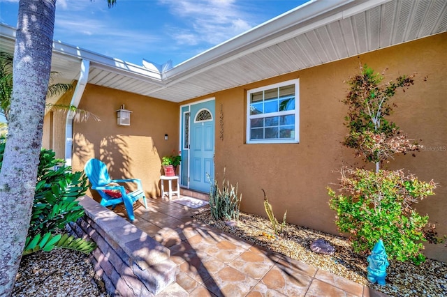 entrance to property featuring stucco siding