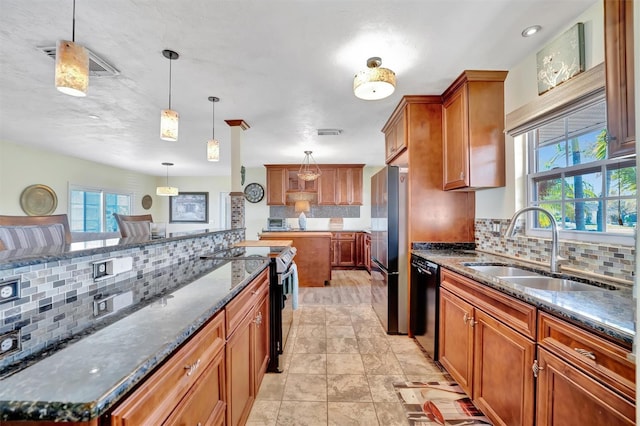 kitchen with visible vents, a sink, range with electric cooktop, dishwasher, and brown cabinets