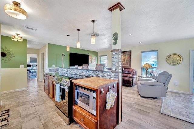 kitchen with visible vents, backsplash, appliances with stainless steel finishes, and open floor plan