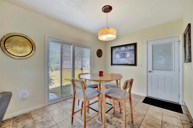 dining area featuring light tile patterned floors and baseboards