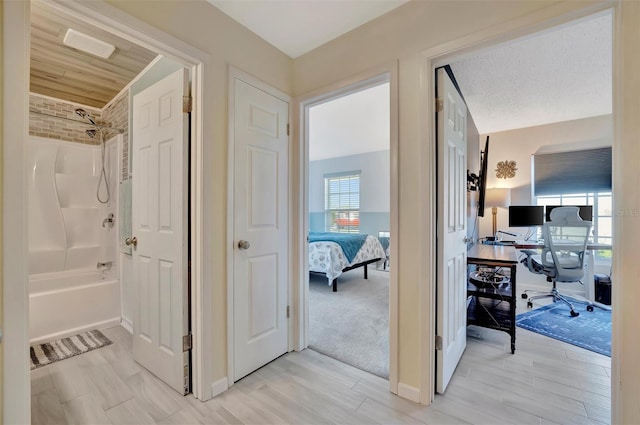 hallway with light wood-style floors