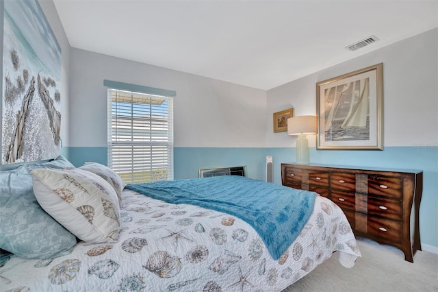 carpeted bedroom featuring visible vents