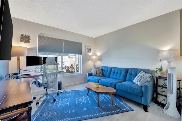 office area with baseboards and a textured ceiling