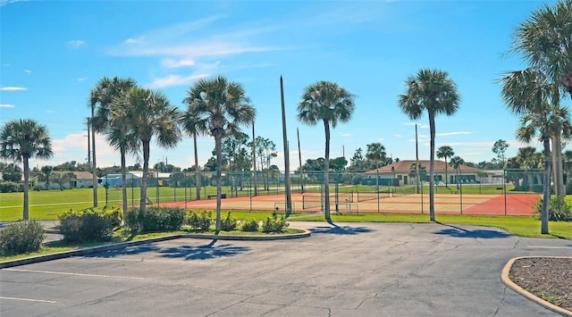 view of home's community featuring fence and uncovered parking