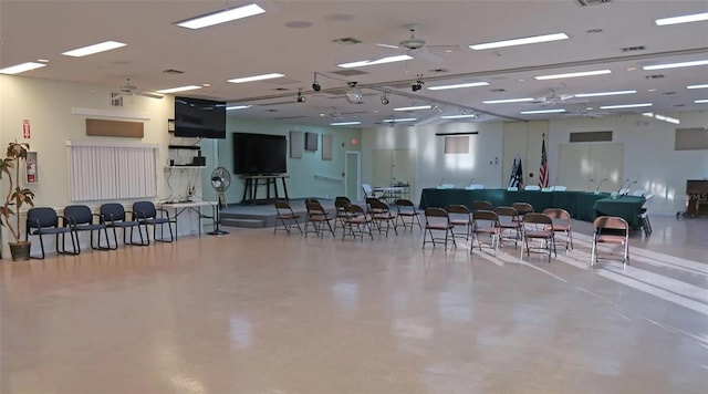 miscellaneous room featuring finished concrete floors, visible vents, and ceiling fan