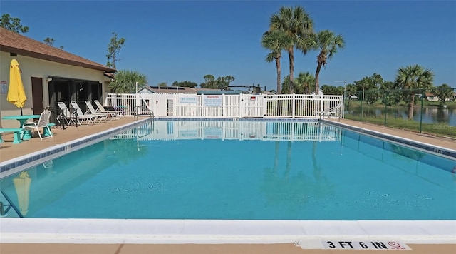 pool featuring a patio area and fence