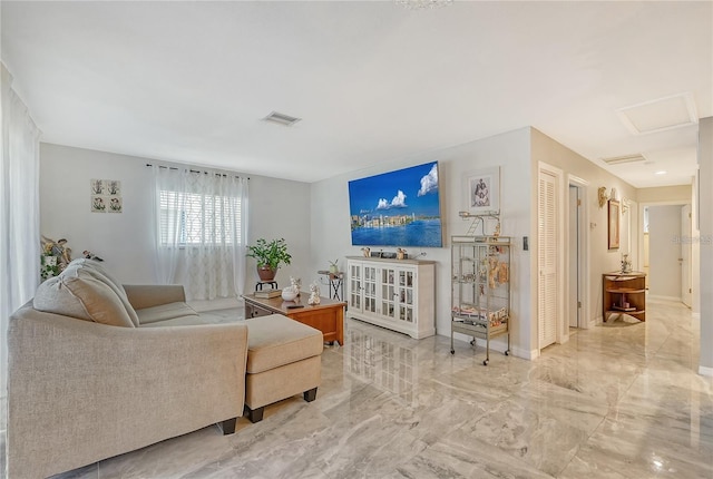 living area with attic access, baseboards, visible vents, and marble finish floor