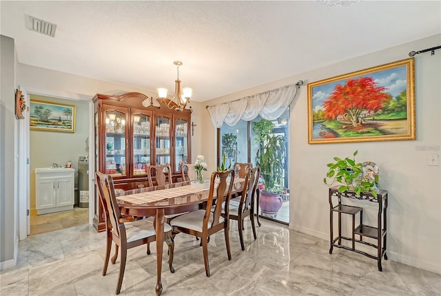 dining room featuring an inviting chandelier, baseboards, and visible vents