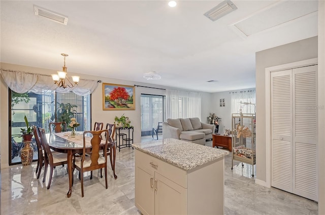 dining room with a notable chandelier, visible vents, and a wealth of natural light