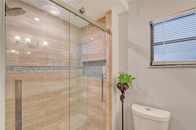 bathroom with toilet and a stall shower